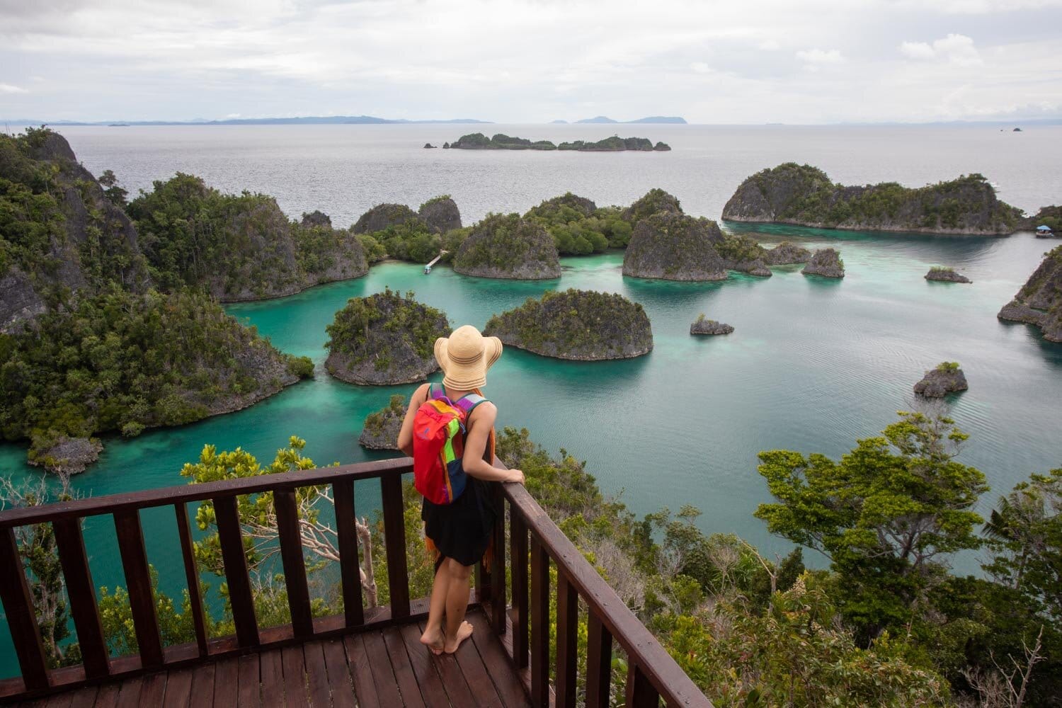 A woman looks over a chain of islands in the Raja Ampat region of Indonesia. 