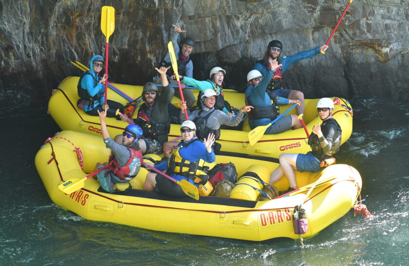 River guides in training stop to wave at the camera after running Tunnel Chute on the Middle Fork of the American River.