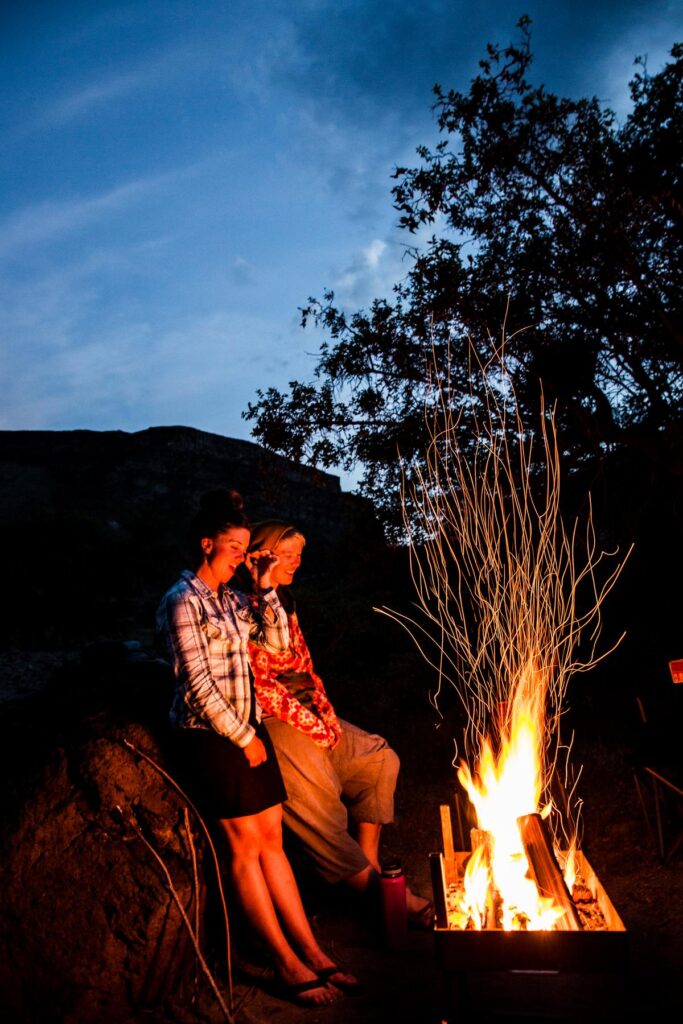 Enjoying a camp fire on an OARS Owyhee River trip.