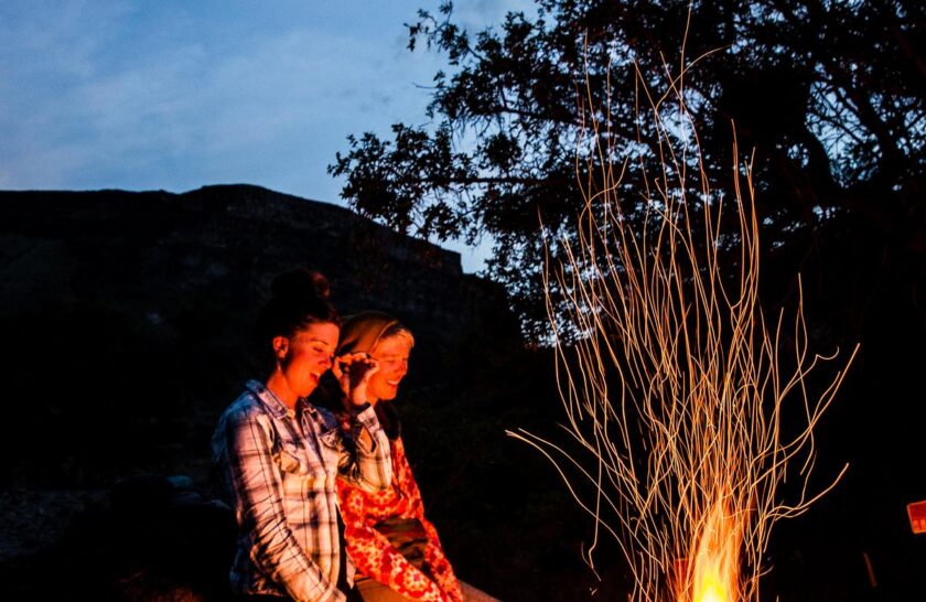 Enjoying a camp fire on an OARS Owyhee River trip.
