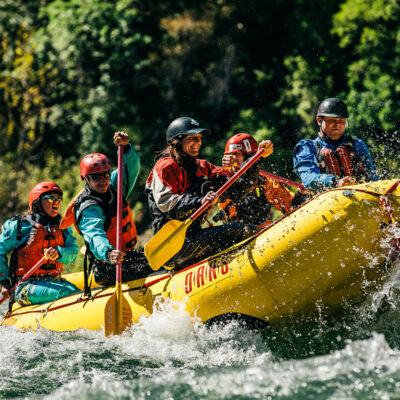 A paddle raft with guides in training go through a rapid on the American River in California