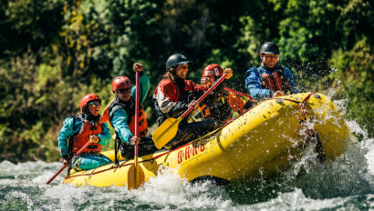 A paddle raft with guides in training go through a rapid on the American River in California