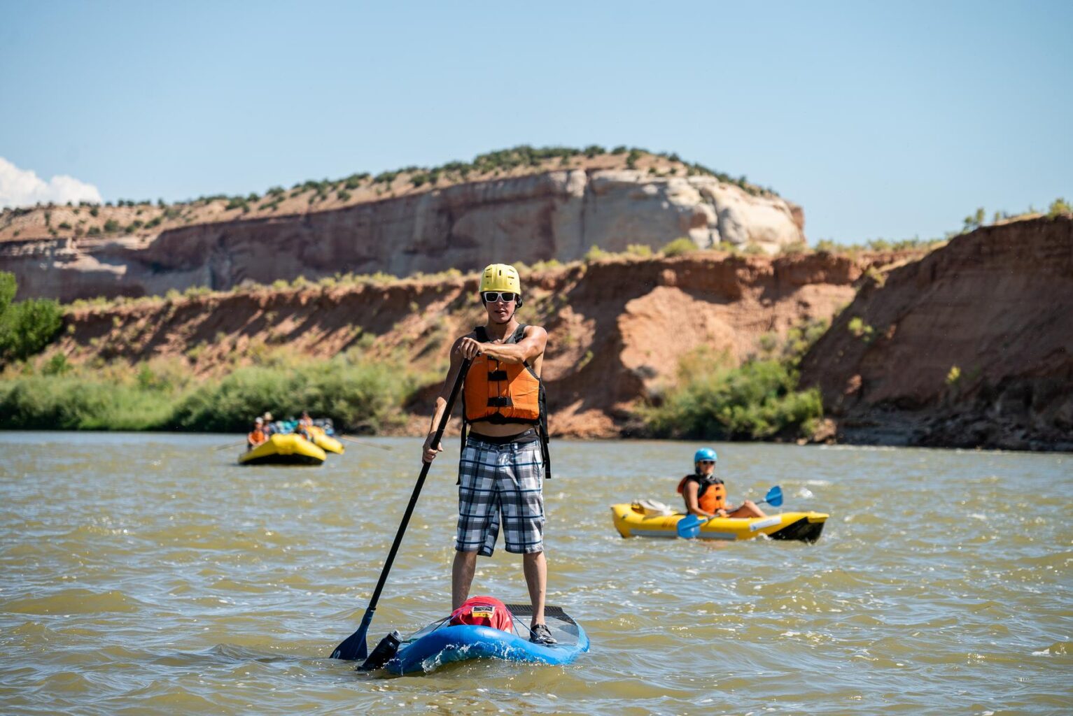 A standup paddler on the water during an OARS Westwater trip