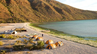 View from above of camp set up on the beach next to the ocean on a Sea Kayaking Espiritu Santo Island trip in Baja Mexico