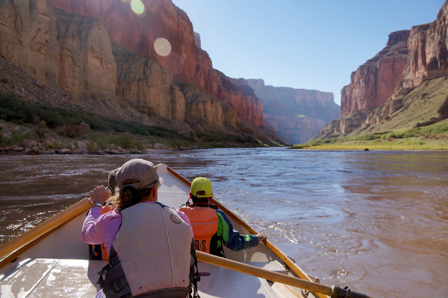 A scenic shot of Grand Canyon from the point of view of a guest in the back of a dory on the Coloardo River