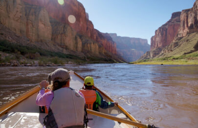 A scenic shot of Grand Canyon from the point of view of a guest in the back of a dory on the Coloardo River
