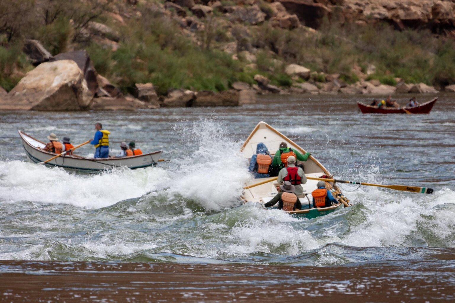 A dory splashes through a rapid on the Colorado River in Grand Canyon