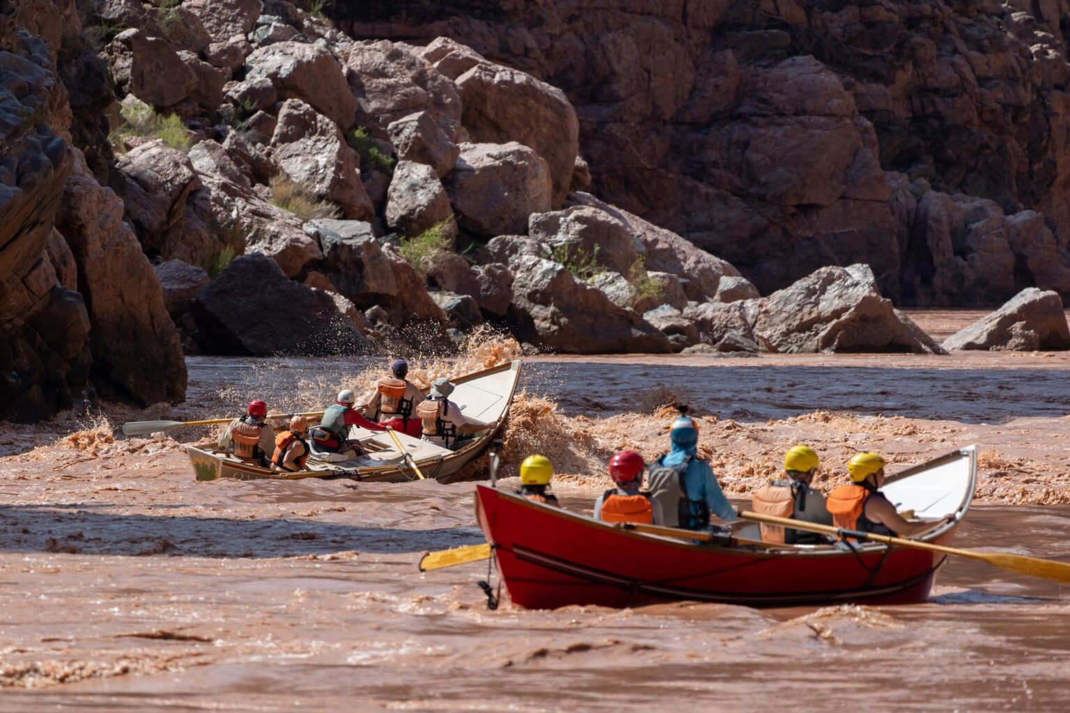 A pair of OARS dories going through a rapid on the Colorado River