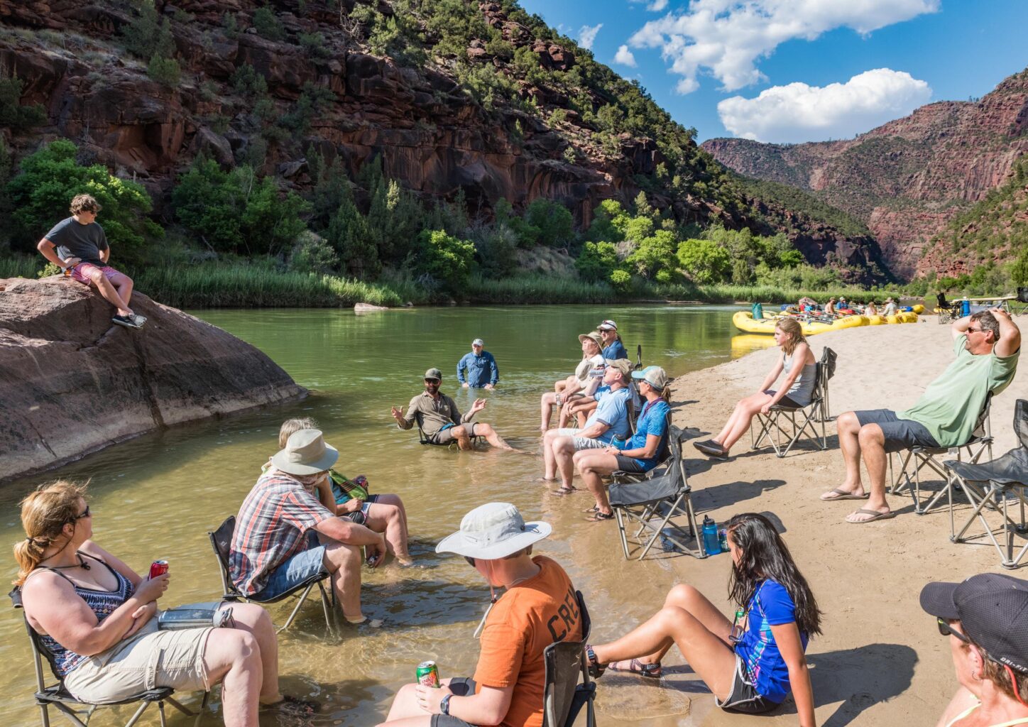 Guests relaxing in camp chairs on an OARS Gates of Lodore trip