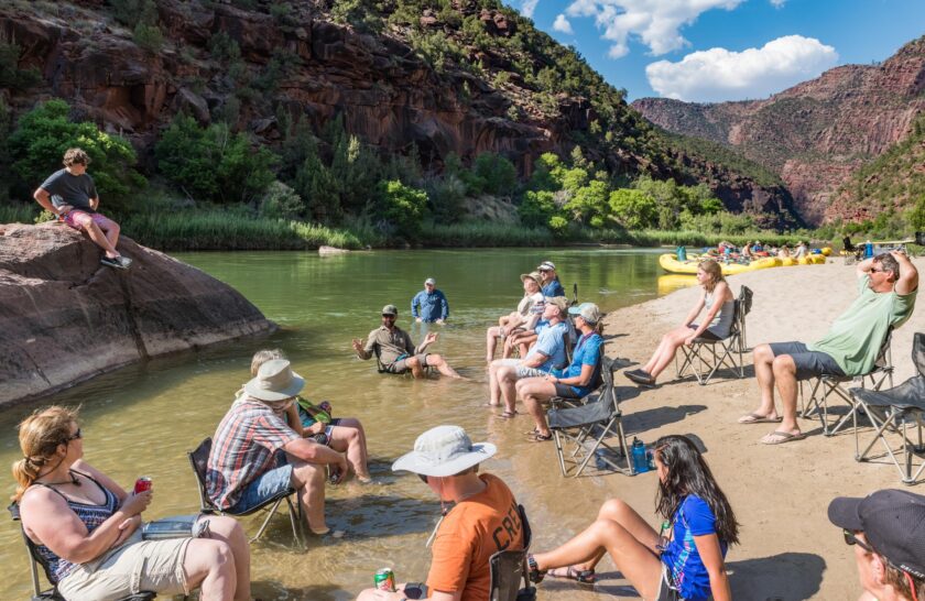 Guests relaxing in camp chairs on an OARS Gates of Lodore trip