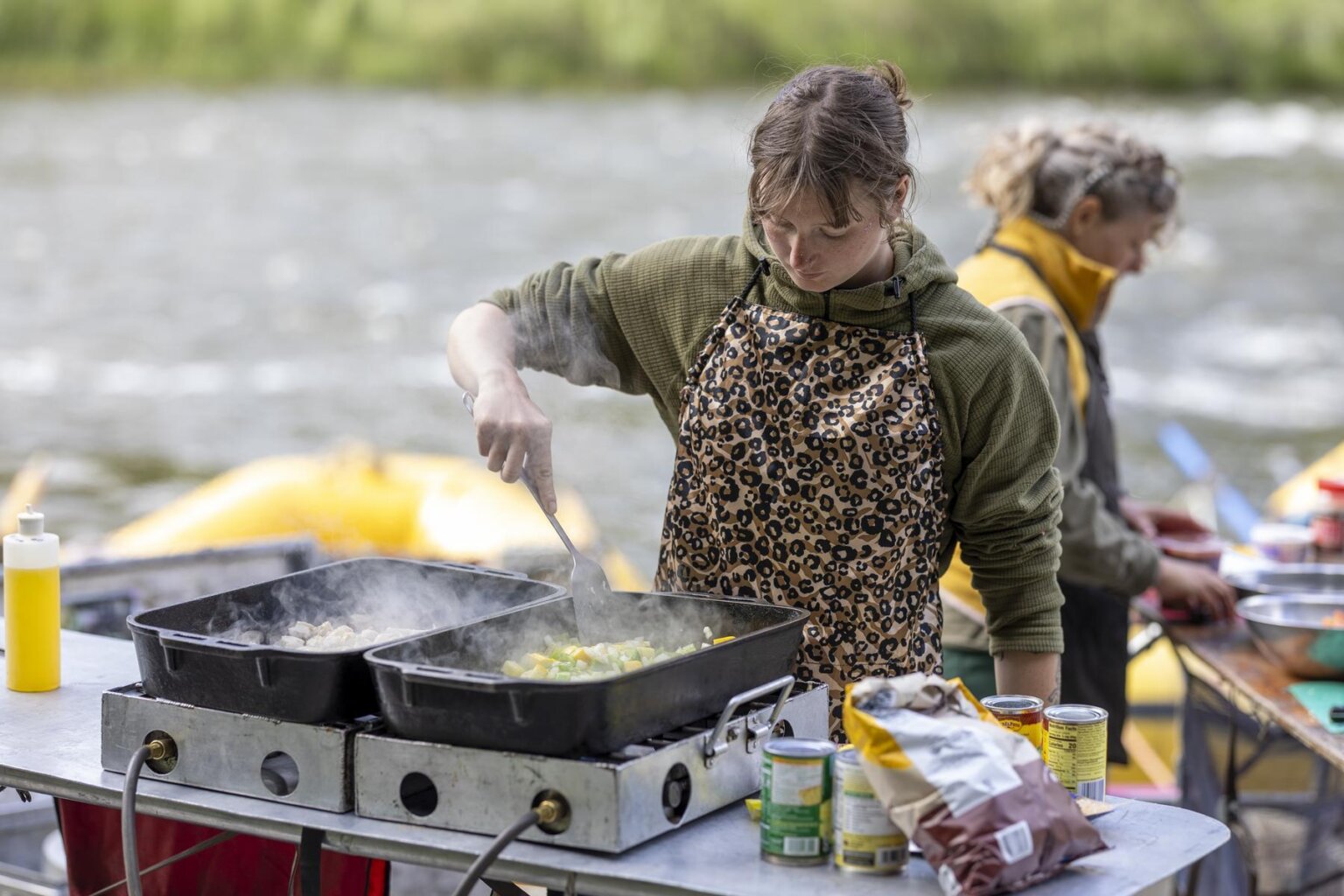 Two guides cooking on the side of the Klamath River during a three-day rafting trip with OARS in 2025.