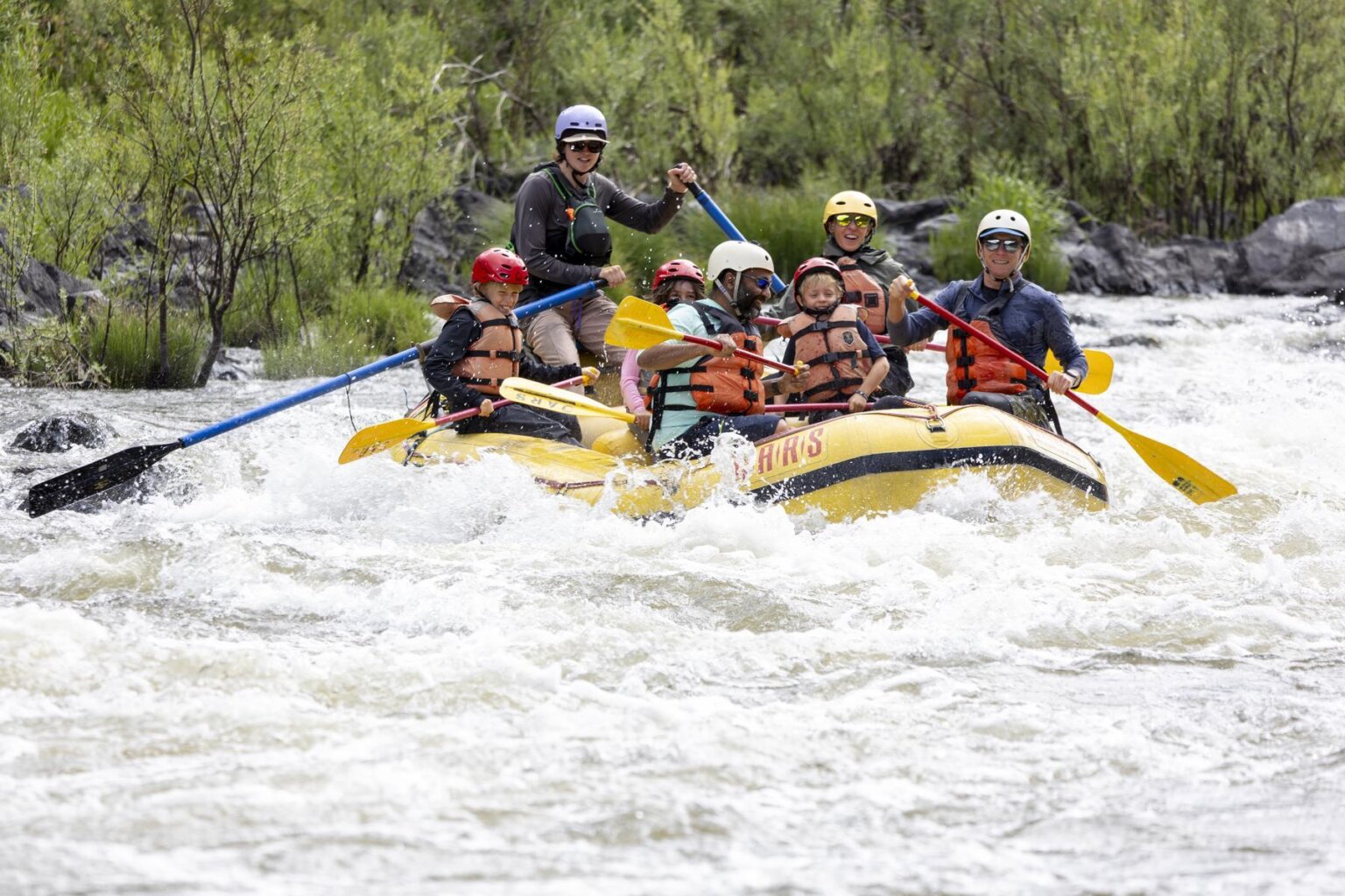 A group of rafters go through small whitewater waves on the Klamath River in Northern California during an OARS rafting trip.