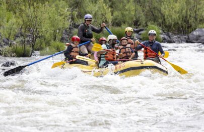 A group of rafters go through small whitewater waves on the Klamath River in Northern California during an OARS rafting trip.