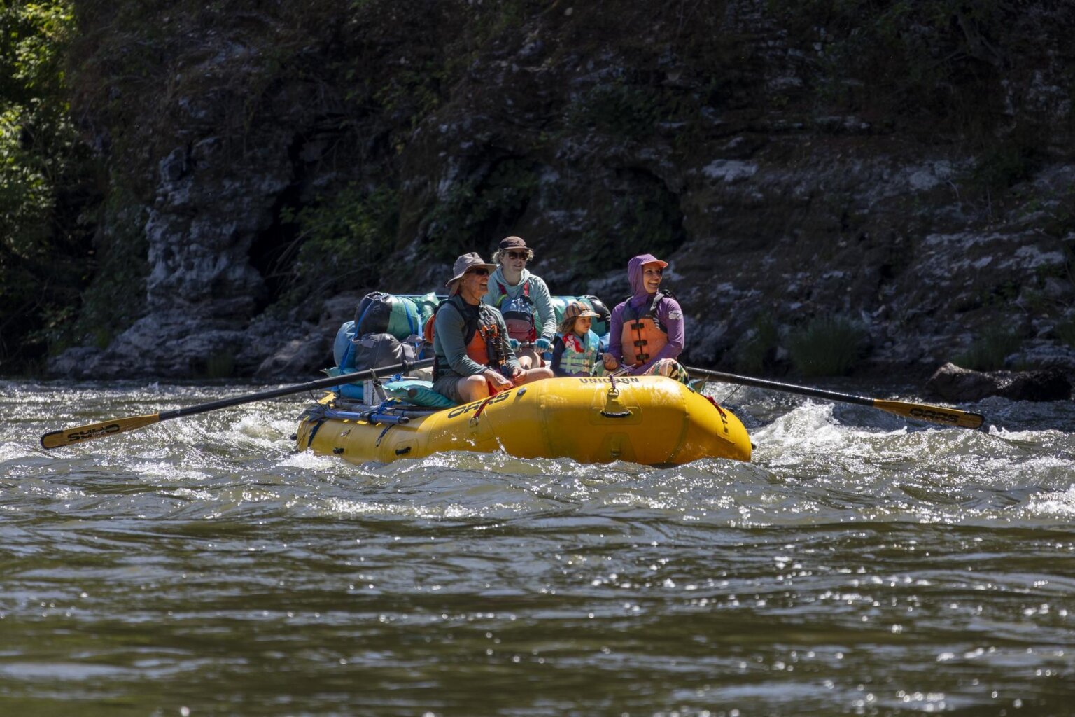 A Grandpa, a child and a Mom raft the Klamath River in 2025.