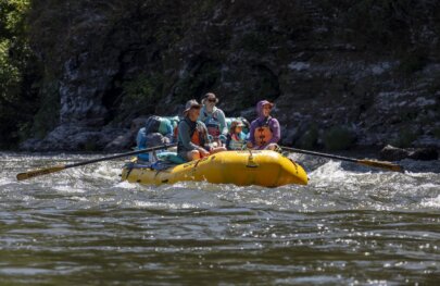 A Grandpa, a child and a Mom raft the Klamath River in 2025.