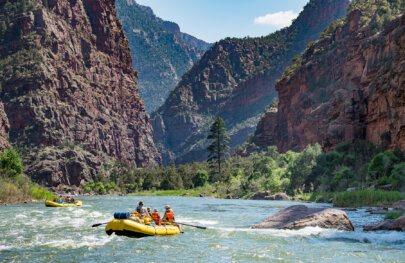Two yellow OARS rafts full of people on the Green River through the Gates of Lodore.