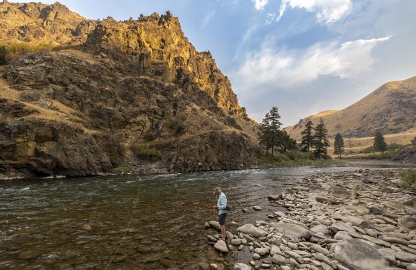 A fly fisherman near the edge of the Middle Fork Salmon River in Idaho.