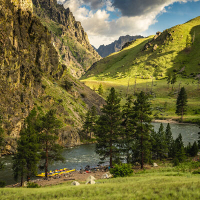 Vibrant green landscape view of camp on an OARS Middle Fork of the Salmon River trip.