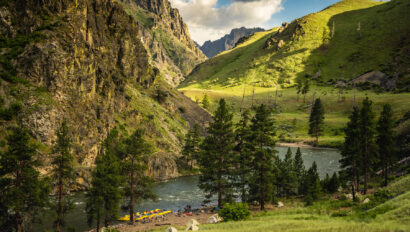 Vibrant green landscape view of camp on an OARS Middle Fork of the Salmon River trip.