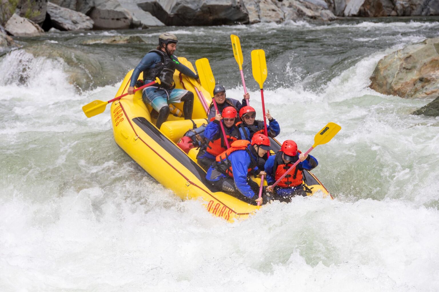 An OARS guides holds on while guiding a boat down Bogus Thunder Rapid on the North Fork American River.