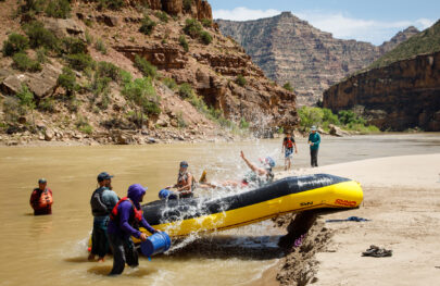 Enjoying a boat slide on a Desolation Canyon rafting trip