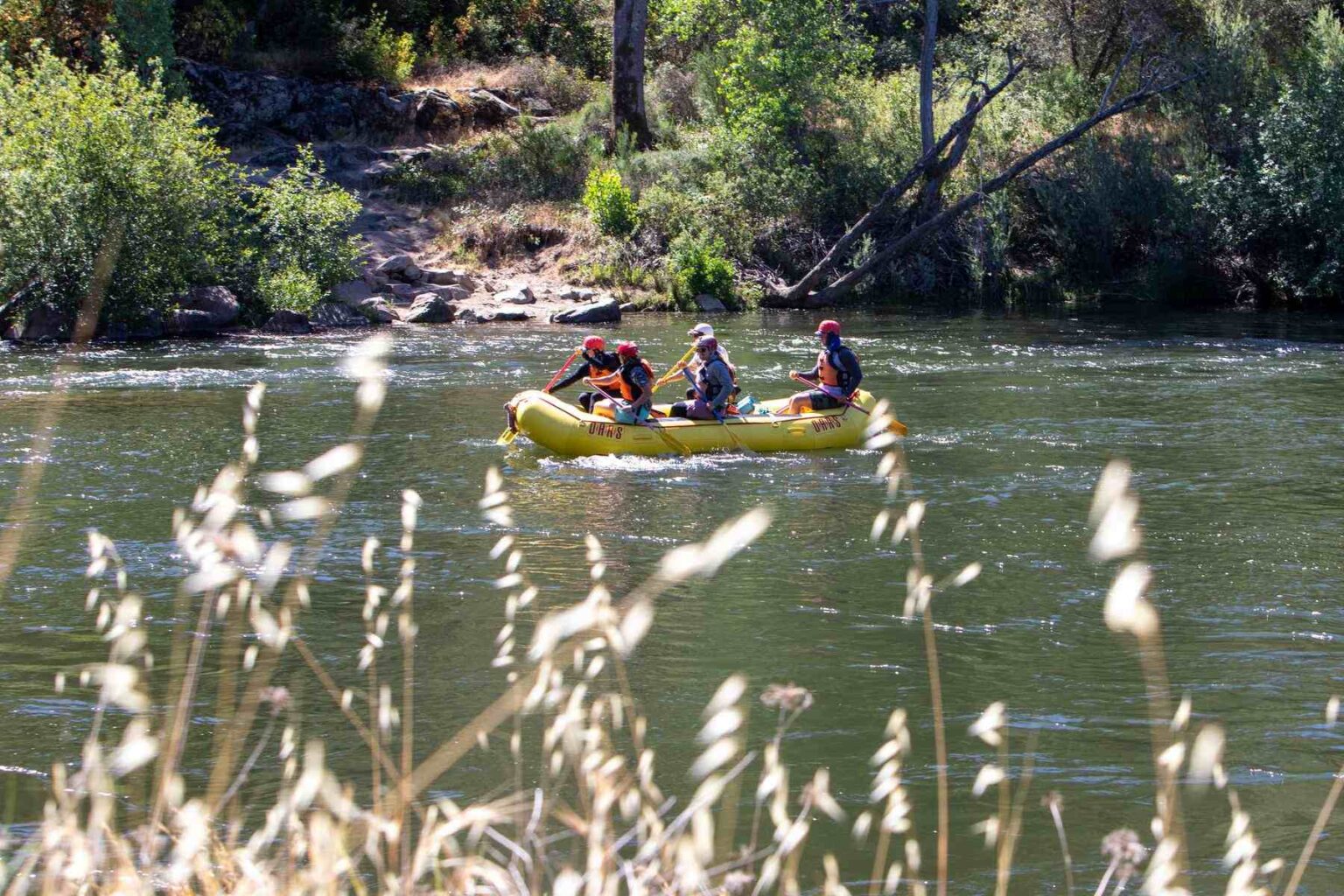 A group of participants in OARS California guide school paddles on the South Fork of the American River