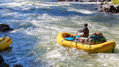 A solo baggage boater rows down the Rogue River in Oregon