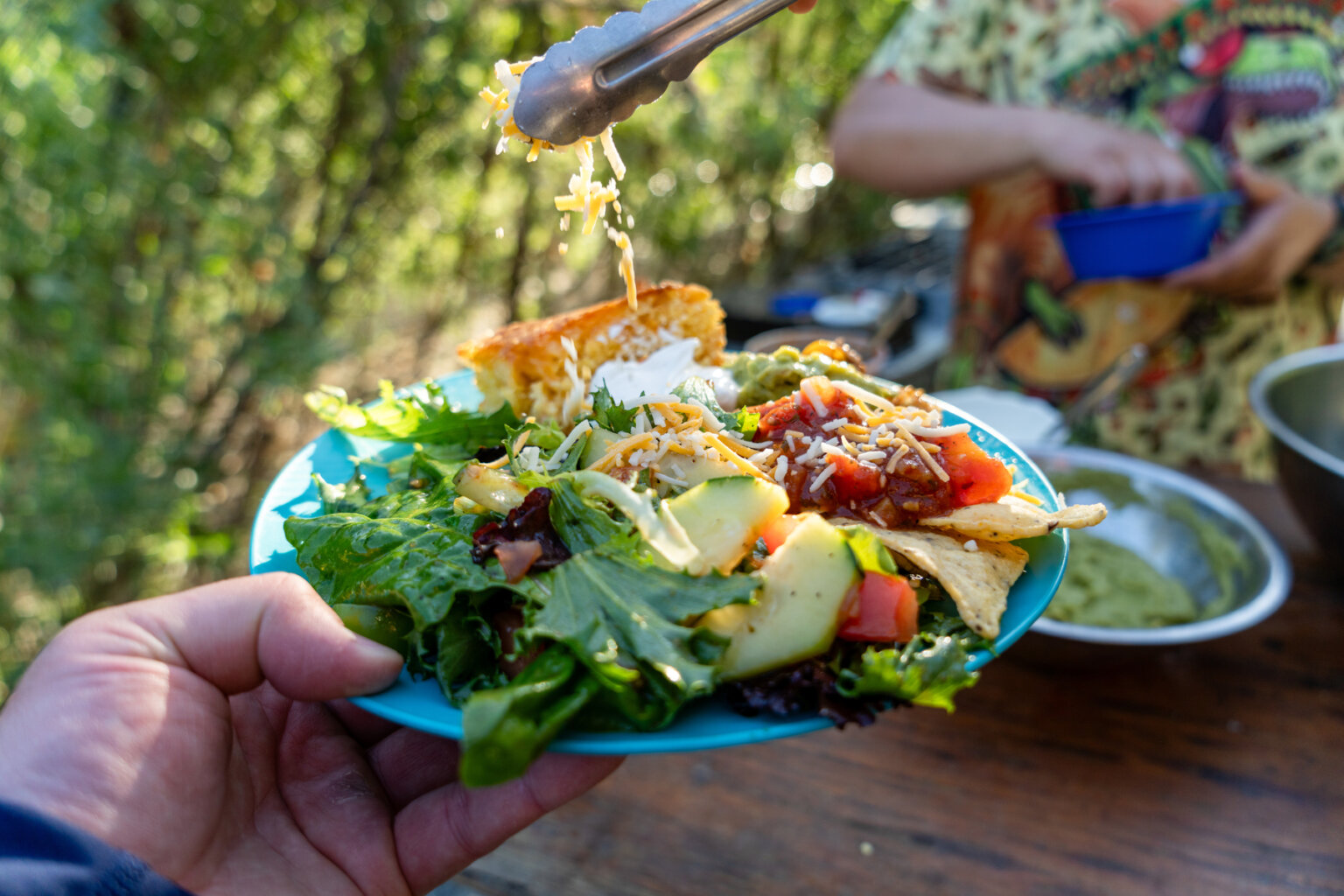 A person holds up a meal on an OARS rafting trip on the Rogue River.