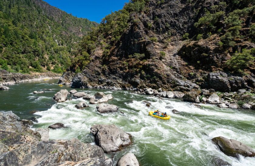 A raft makes its way through Blossom Bar rapid on the Rogue River in Oregon during an OARS rafting trip.
