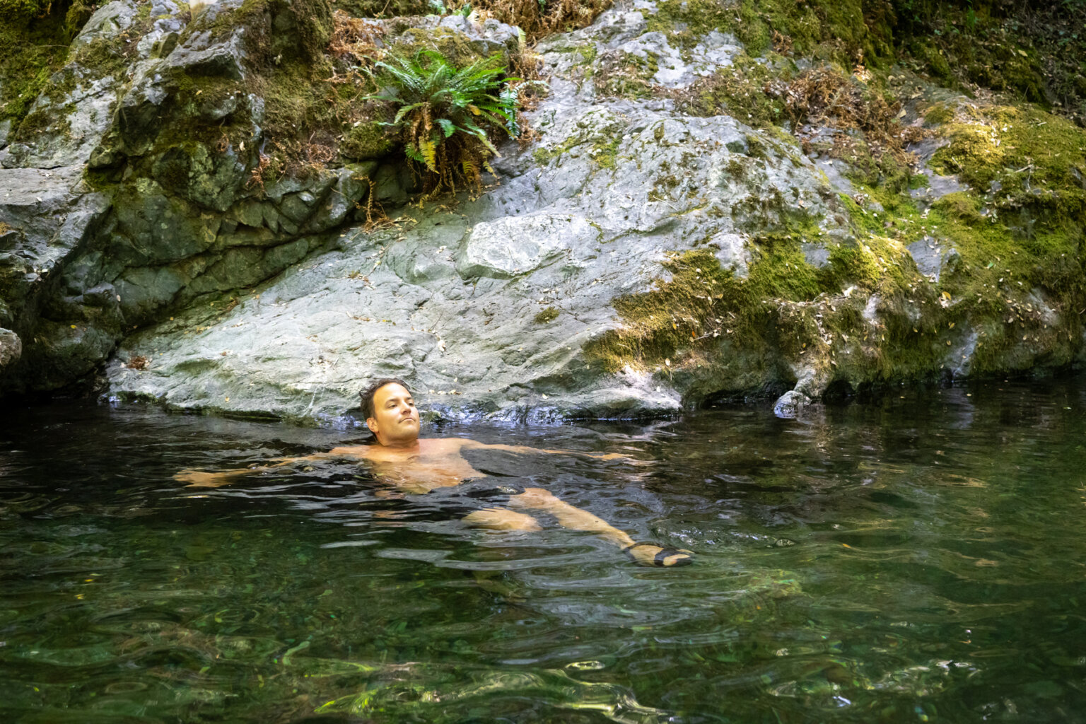 A man swims in clear water during a rafting trip on the Rogue River in Oregon during June, 2025.