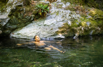 A man swims in clear water during a rafting trip on the Rogue River in Oregon during June, 2025.