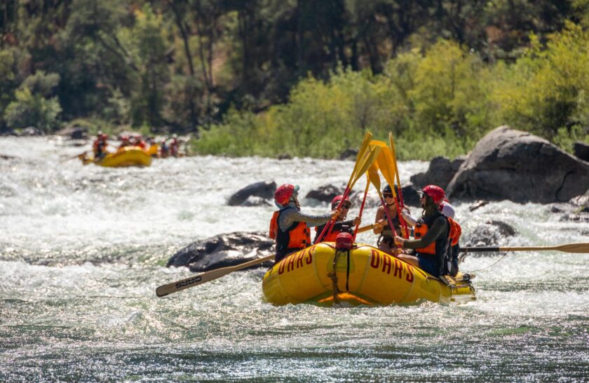 Celebrating after rafting a rapid on the Tuolumne River