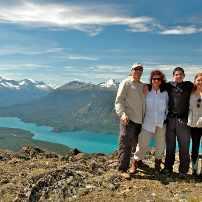A family stands together at the top of an overlook in Alaska