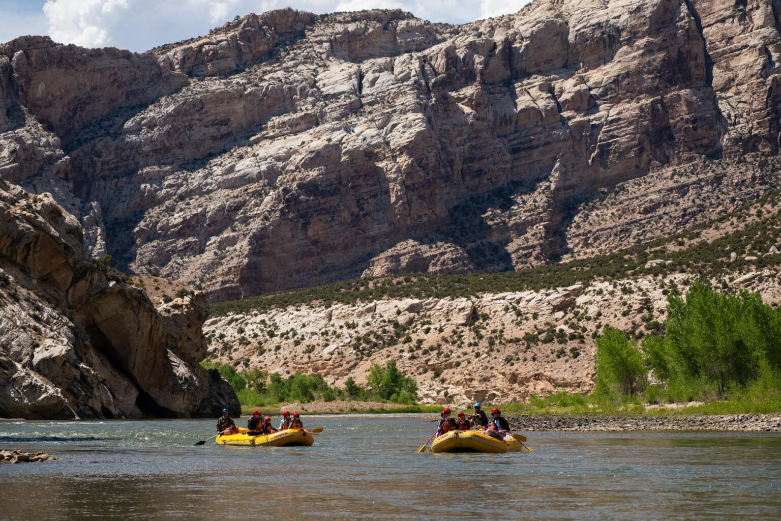 Two yellow OARS rafts in Split Mountain Canyon on the Green River in 2025.