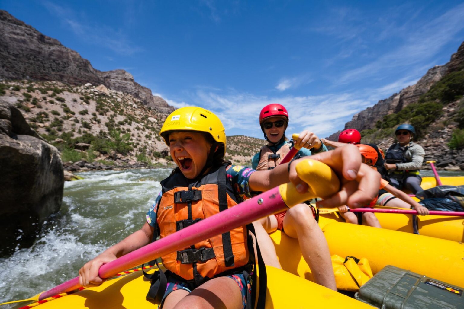 A little girl laughs while rafting the Split Mountain Canyon section of the Green River with OARS in 2025.
