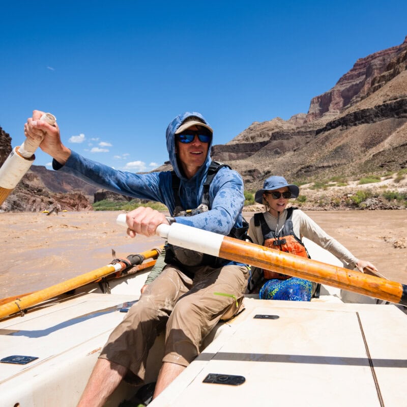 A dory guide and passenger on a Grand Canyon dory trip with OARS