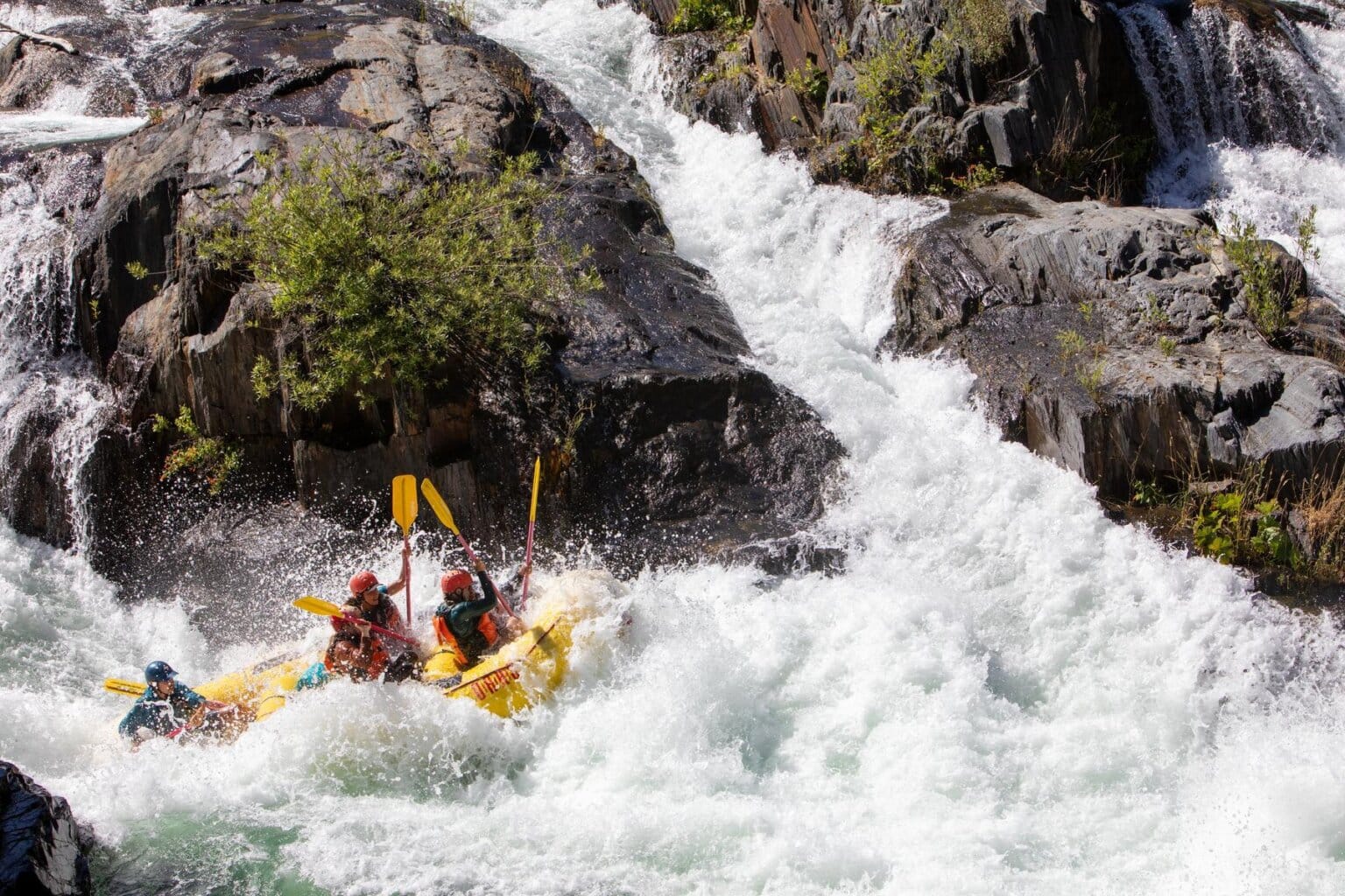 A yellow raft filled with paddlers hits Tunnel Chute Rapid on the Middle Fork of the American River