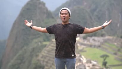 A man celebrating good news at Machu Picchu.