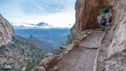 A hiker on the Grand Canyon's Bright Angel Trail descends through Upper Tunnel