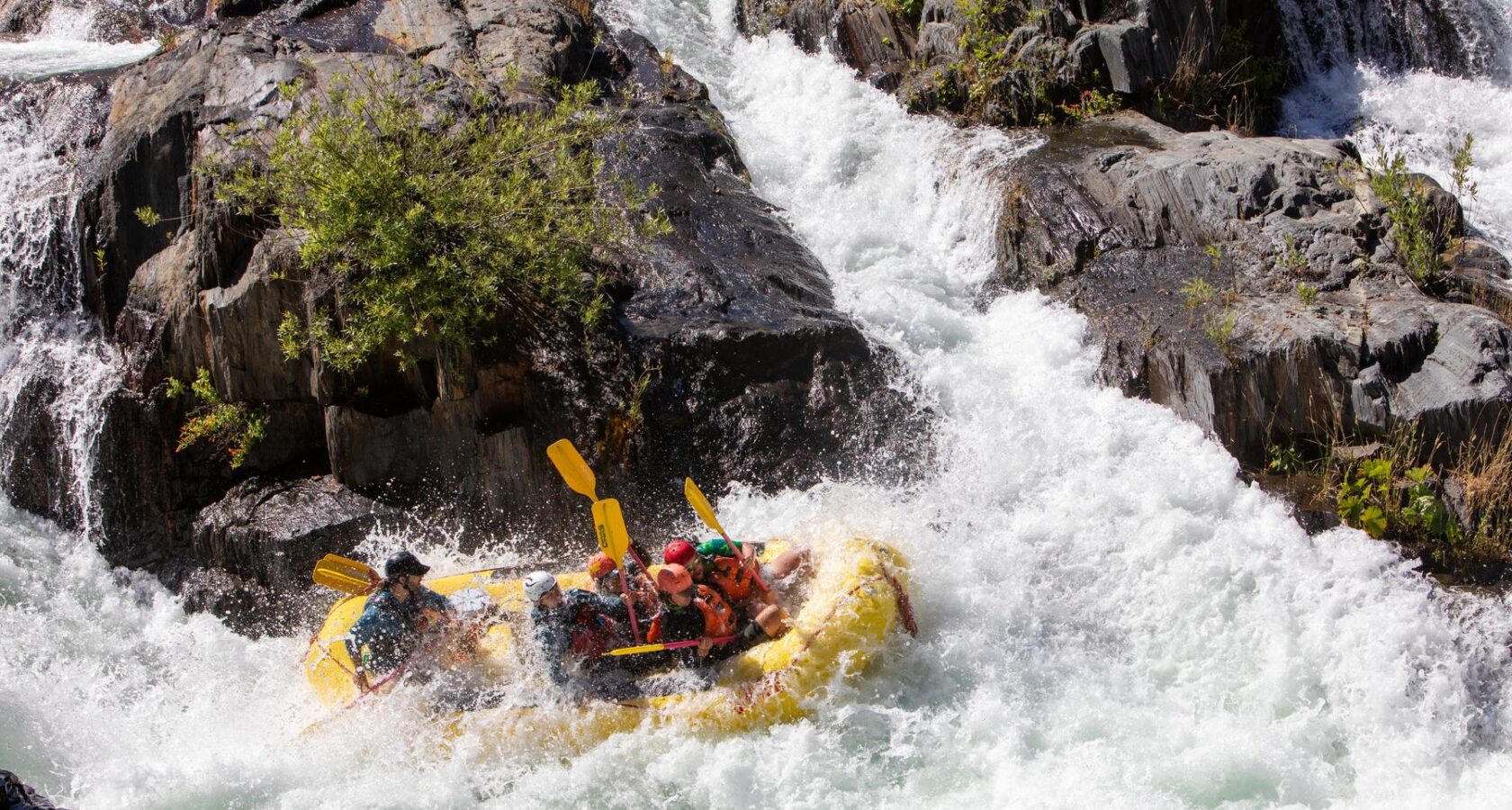 Rafters plunging down Tunnel Chute rapid on the American River