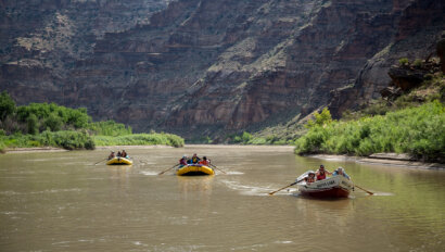 Two yellow rafts and a dory make their way downriver on an OARS John Wesley Powell Retrace trip