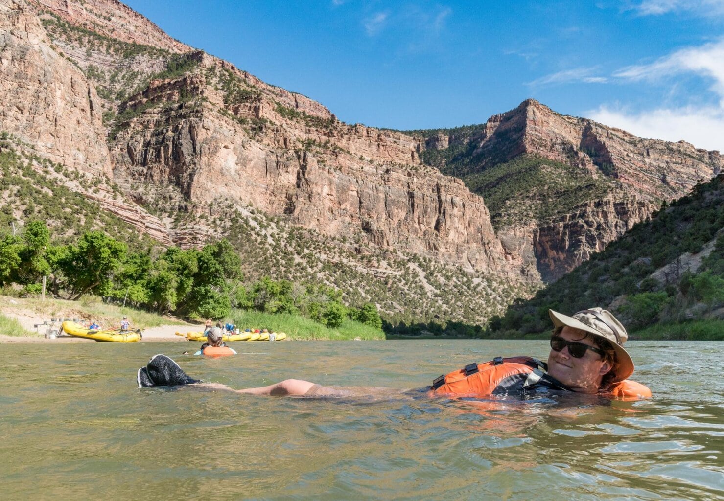 Woman in a PFD floating on her back in the Green River