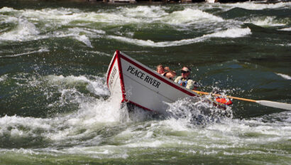 A man rowing a dory slices through whitewater on Idaho's Lower Salmon River