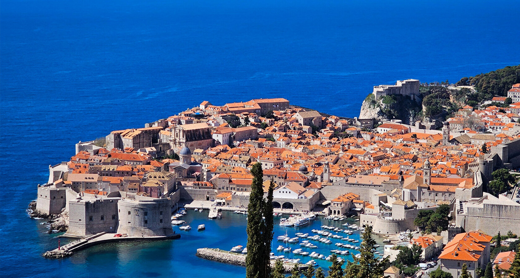 Aerial shot of Dubrovnik in Croatia featuring the town's historic red roofs