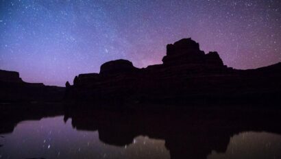Starry night over a silohuette of a Utah canyon in Canyonlands National Park