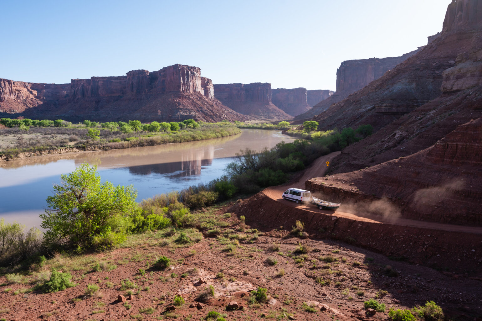A van with a boat hitched to the back drives the road to the Mineral Bottom put-in on the Colorado River