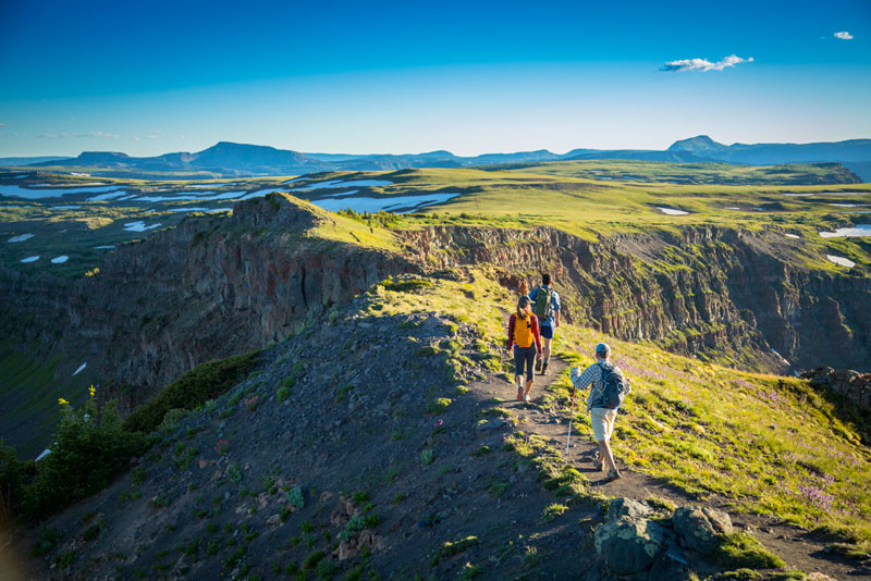 Hikers ascend a rocky ridgeline on a Colorado Road Trip: Denver to Dinosaur National Monument Loop