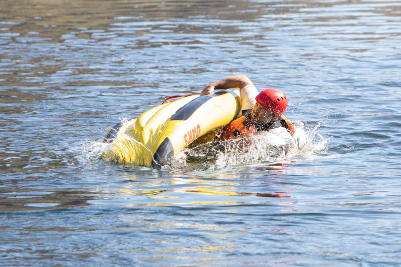 An OARS guests flips over in an inflatable kayak.