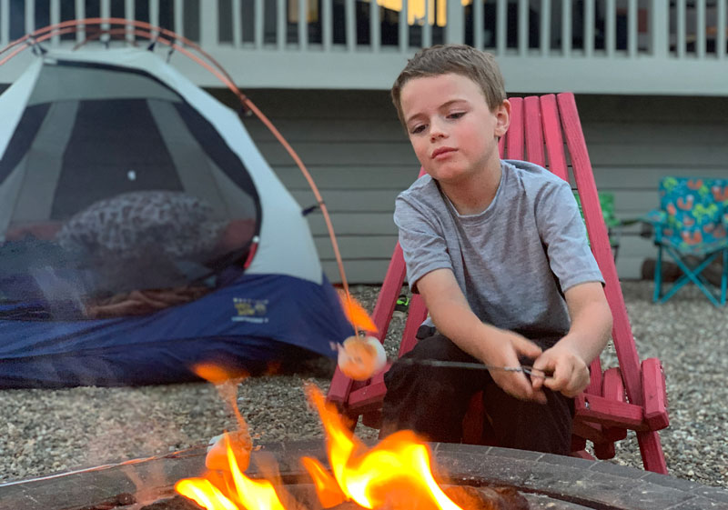 boy roasting marshmallow over fire