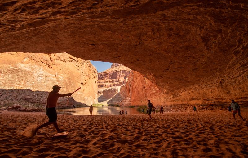 Get to Know the River Permit Lottery System for the West's Most Popular Rafting Trips - People playing baseball in a giant cavern along the Colorado River